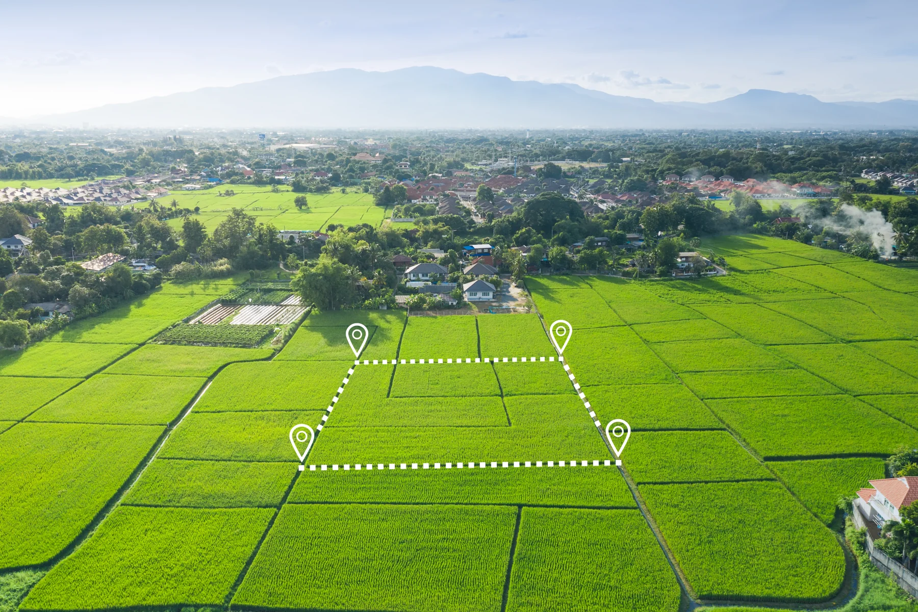 Aerial view of an open property outlined within the surrounding landscape